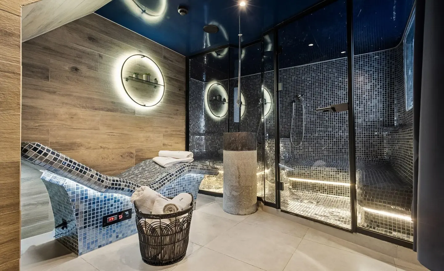 Bella yacht interior deck area with seating, circular wall lights, and blue-tinted ambiance