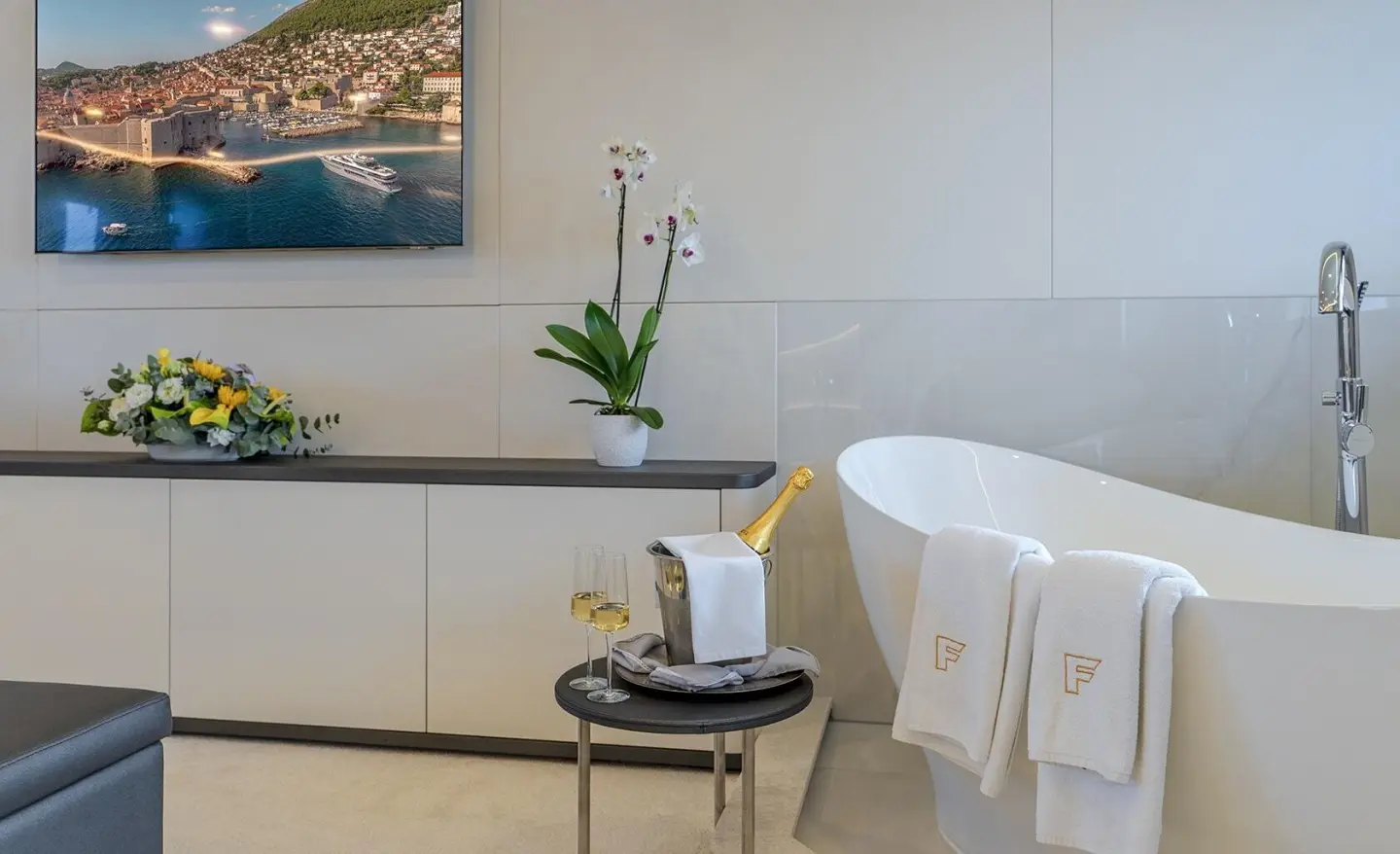 Luxurious yacht bathroom on Freedom with white fixtures and plant on cabinet