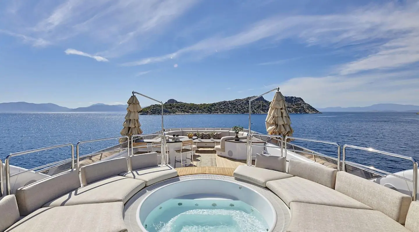 View from deck of Daloli yacht with hot tub, seating, and sea horizon