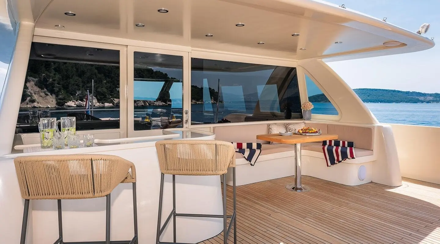 Grace yacht deck seating area with woven chairs and table, ocean view