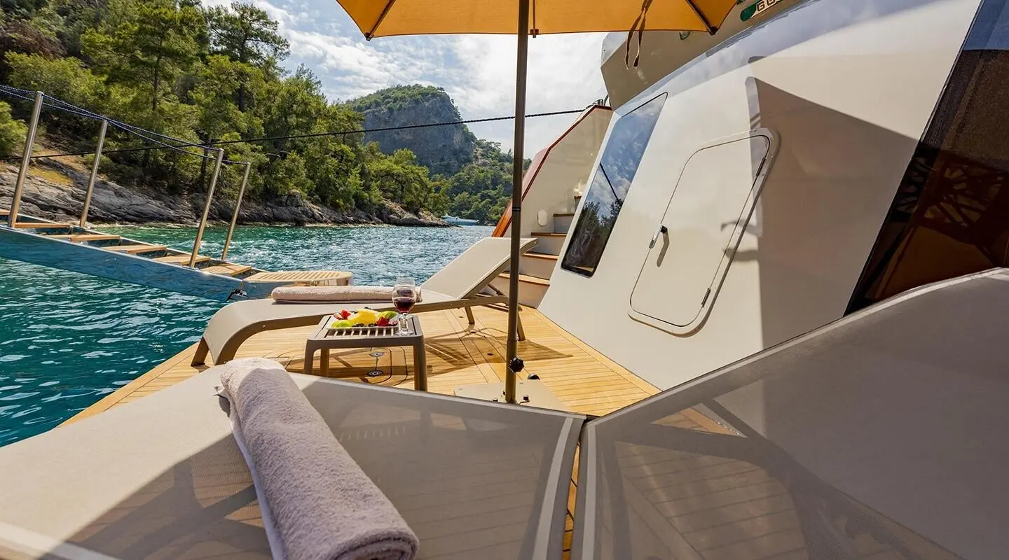 Sunset on luxury Simay M yacht with dining setup on deck and seating