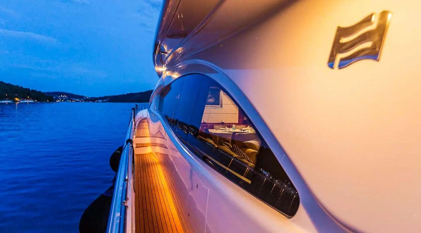 Miss Katariina yacht side deck view with railings and water reflections at dusk