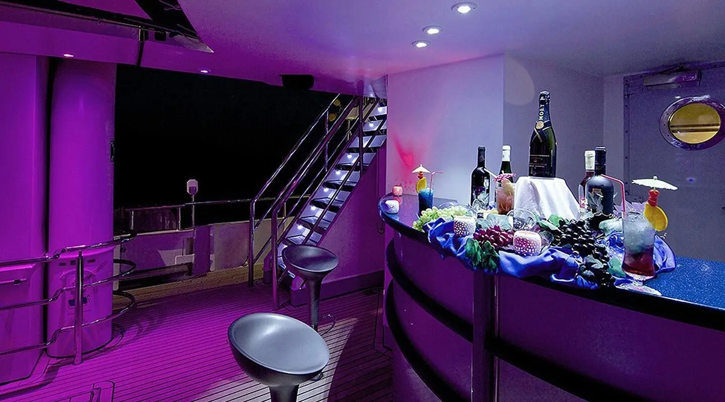 Gulet yacht named Running on Waves on a dark night deck with stairs and bar