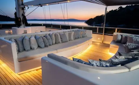 Anima Maris yacht on sunset deck with seating and warm lighting