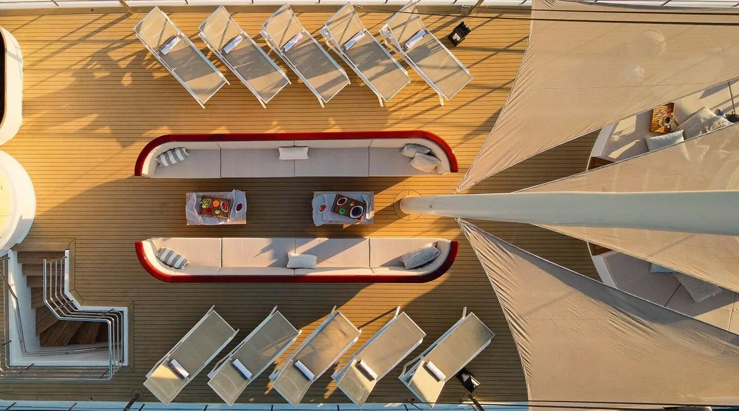 Top-down view of Bellezza yacht at sunset, deck seating and sun loungers