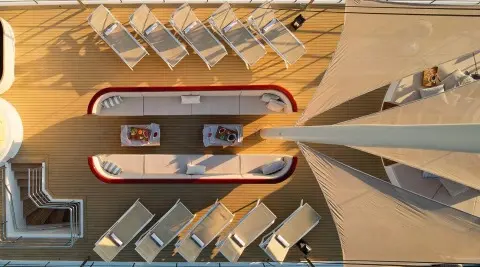 Top-down view of Bellezza yacht at sunset, deck seating and sun loungers