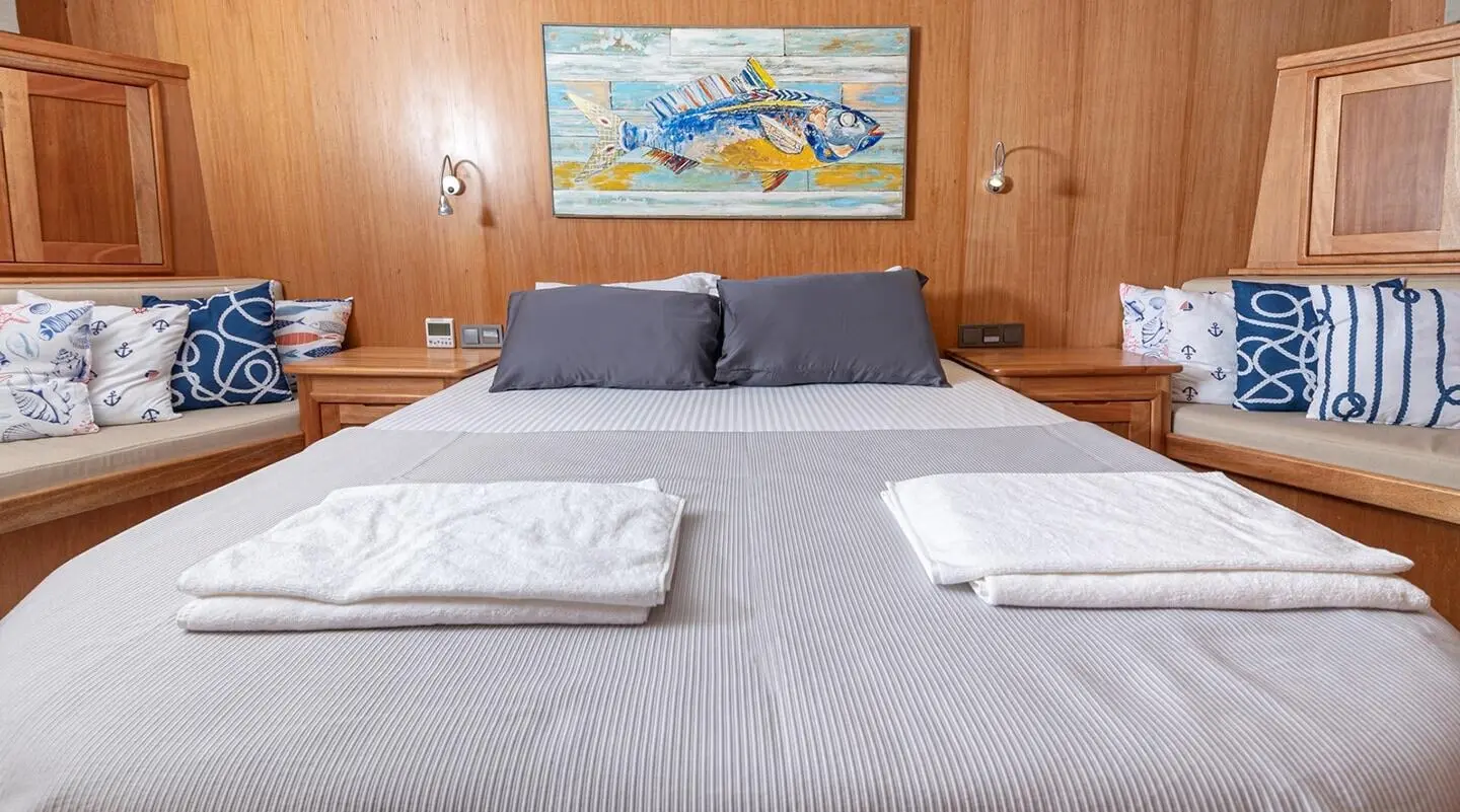 Cozy bedroom aboard Bodrum Queen yacht with double bed and neat towels