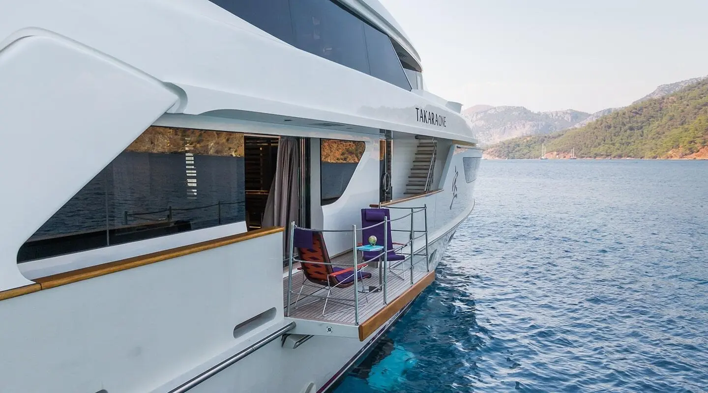Yacht Takara One side view with deck seating overlooking blue sea