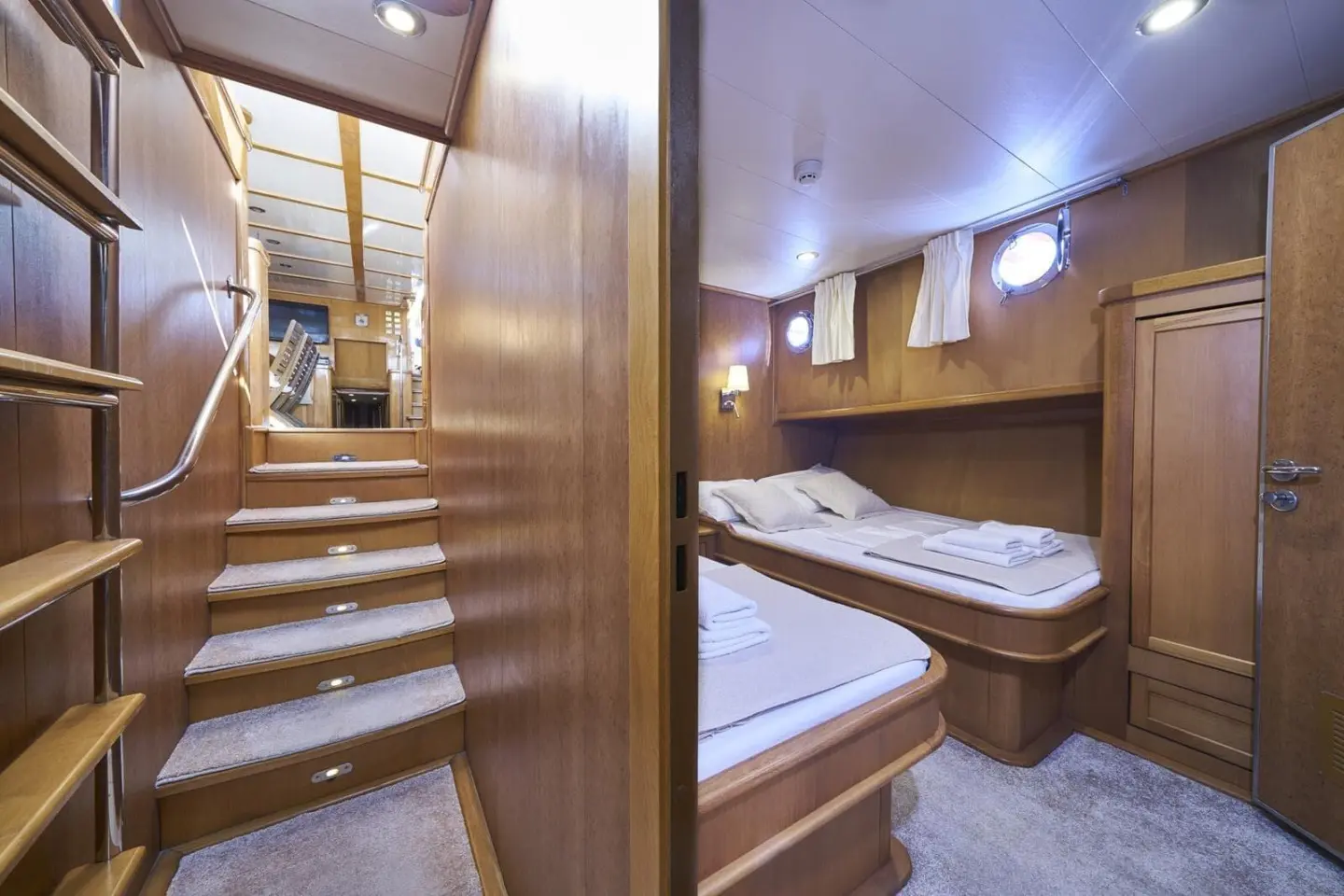 Morning Star yacht interior with wooden walls, twin beds and soft lighting