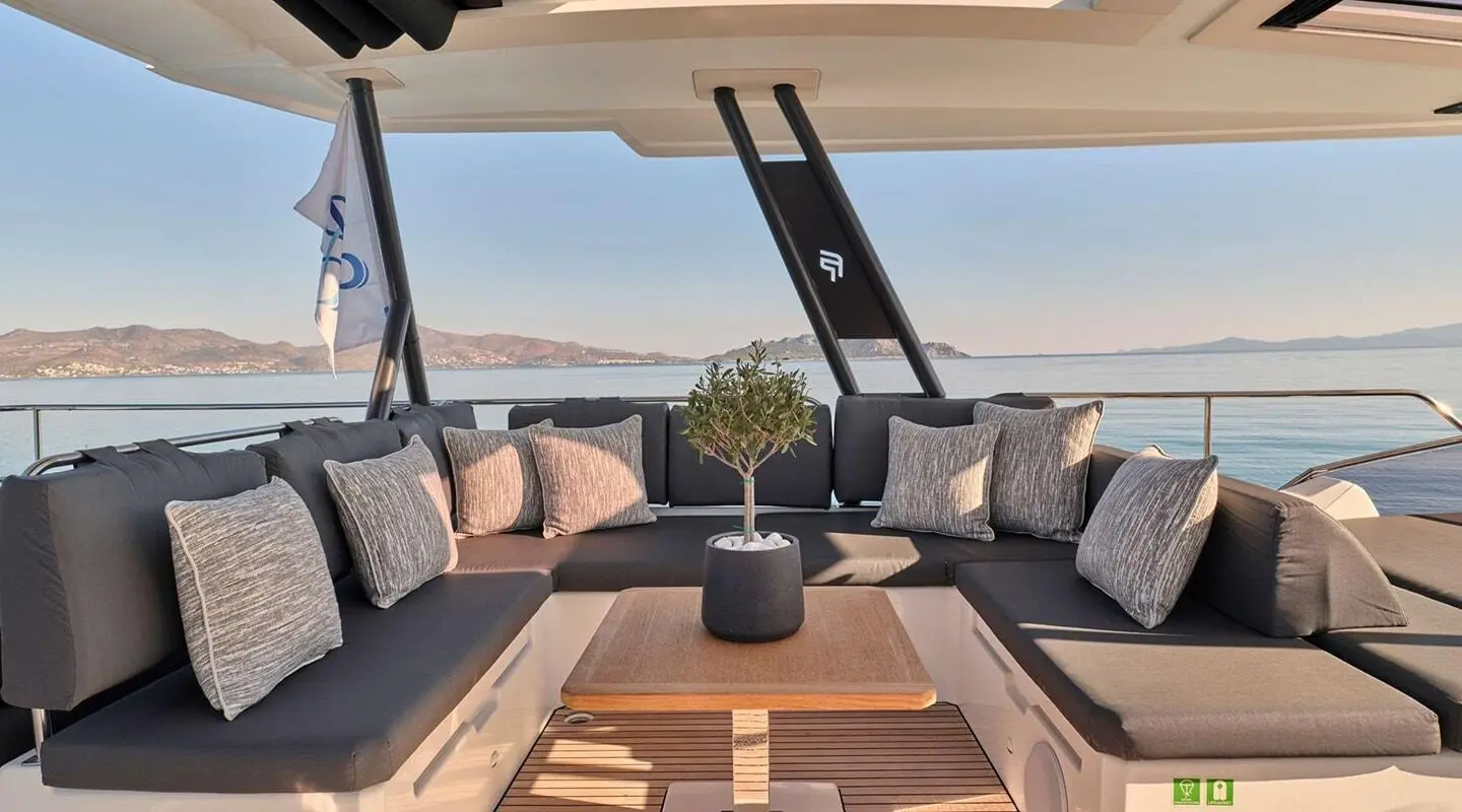Christal Mio yacht cockpit at sunset with comfortable seating and table