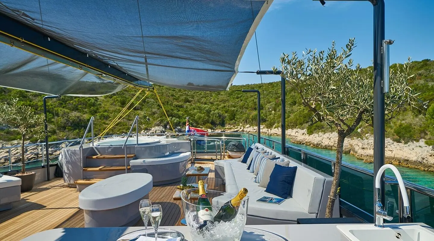 Rara Avis gulet on the sun deck with lounge seating and shaded area