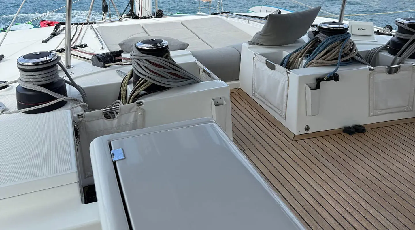 Atlantis yacht deck area with white seating, railings, and wooden deck planks