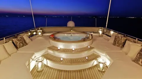 O'Rion yacht deck with circular jacuzzi and sunset skyline view