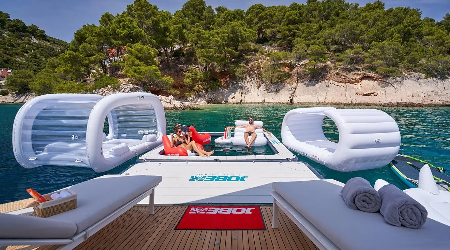Yacht Aluminia Too at dock with people and water toys onboard