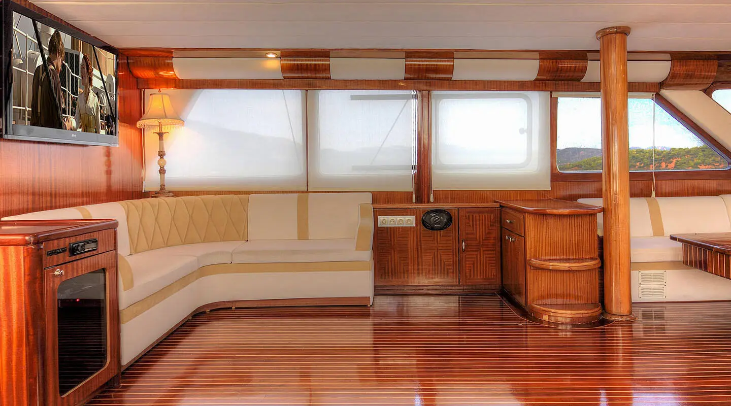 Angelo II luxury yacht interior with cream leather seating and polished wood paneling