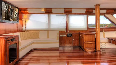 Angelo II luxury yacht interior with cream leather seating and polished wood paneling