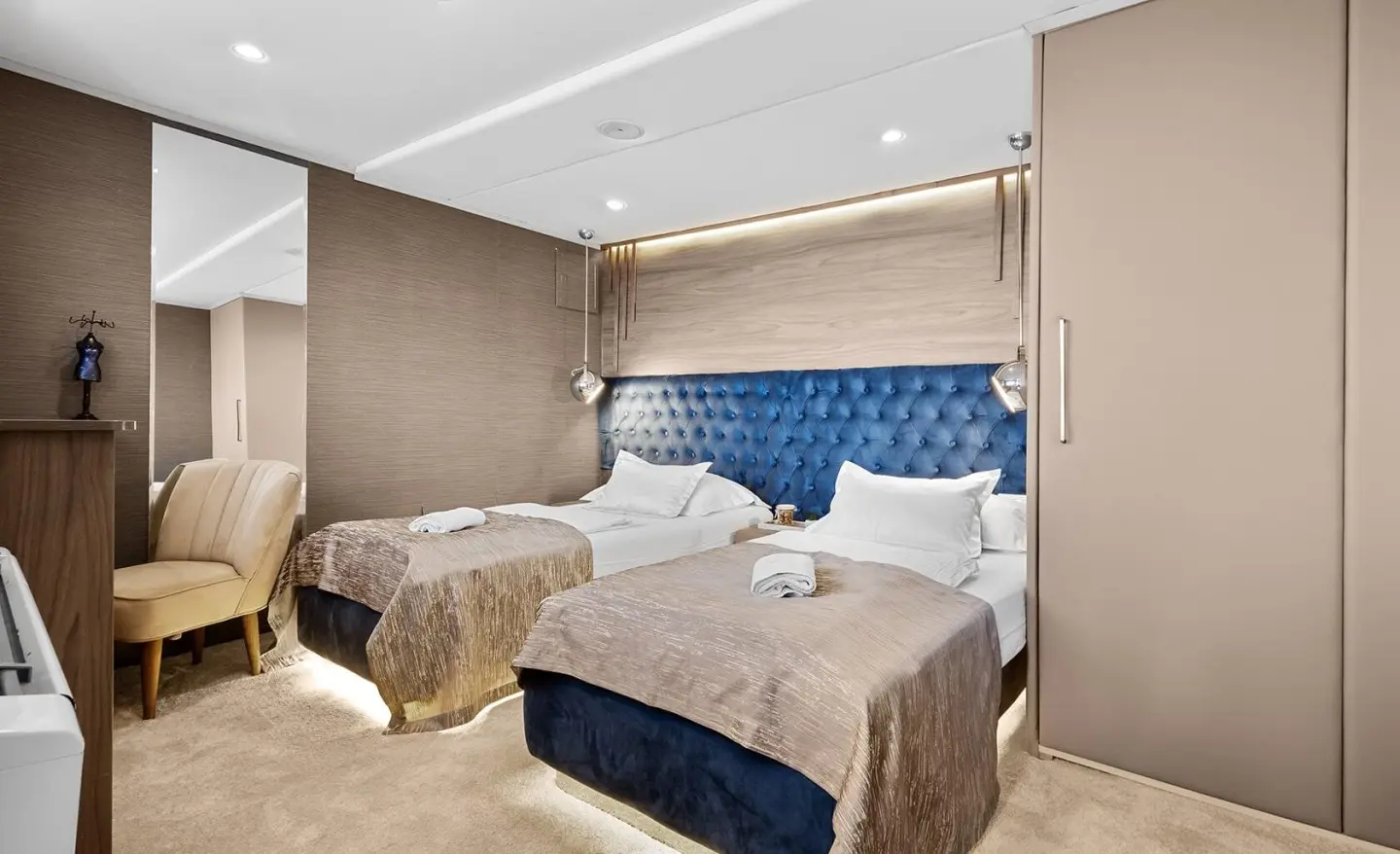 Bella motor yacht twin cabin interior with two beds and seating