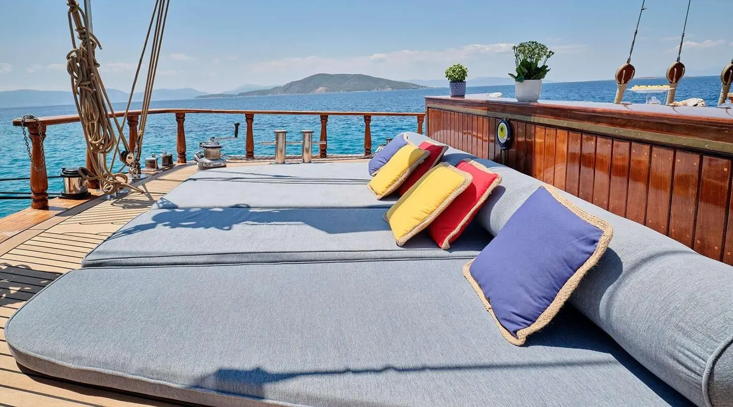 Wide sunbed on open deck with sea view on gulet Myra lounge area