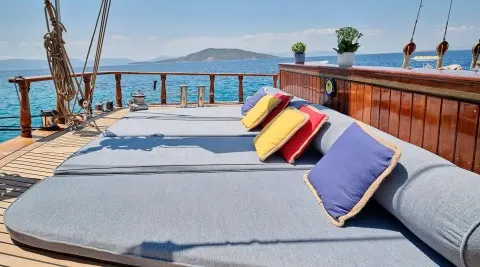 Wide sunbed on open deck with sea view on gulet Myra lounge area