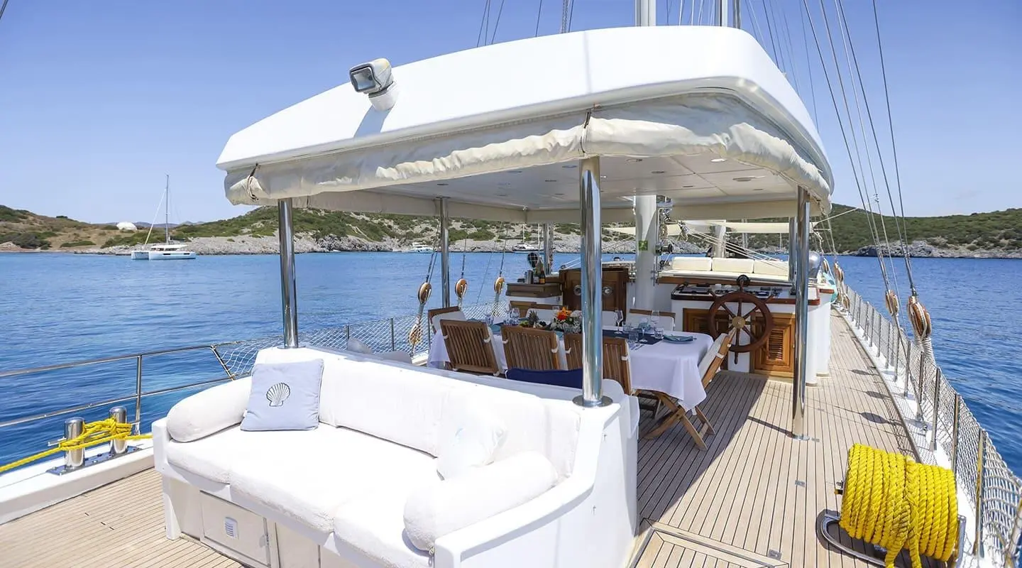 Gazella yacht at sea with shaded cockpit, white upholstery, calm blue water