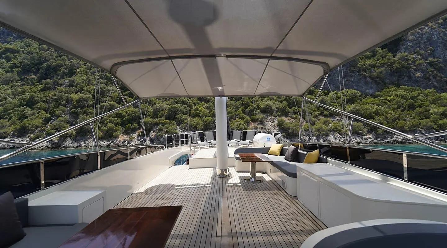 View from yacht deck at sunset with seating and calm blue water