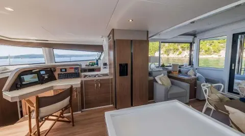 Yacht cockpit aboard Ocean Lounge with seating, wood cabinetry, and windows