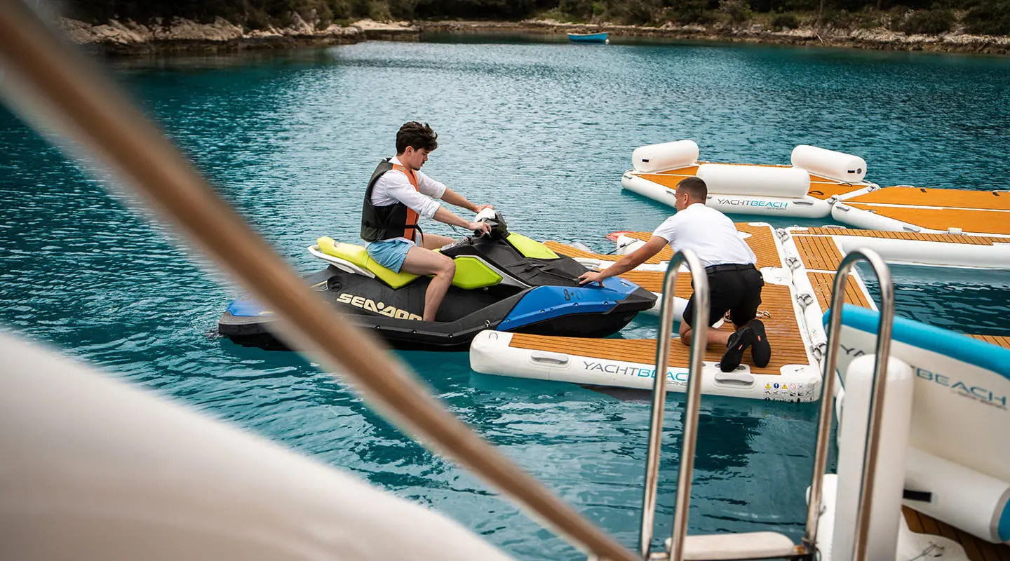 Cristal yacht at sea with passengers on a small tender near the pool