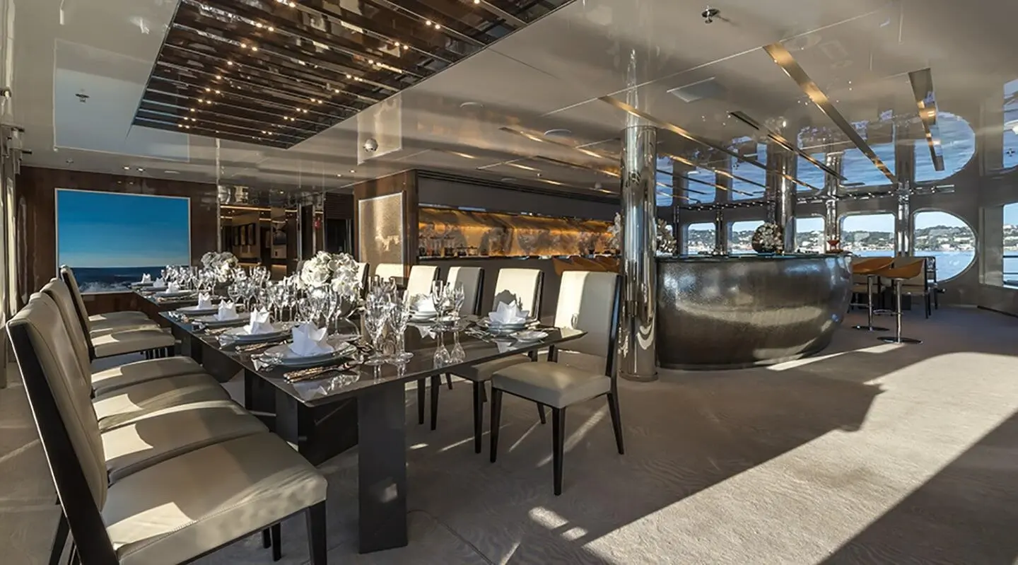 Marquise luxury yacht dining saloon; polished wood, tables set, ambient lighting