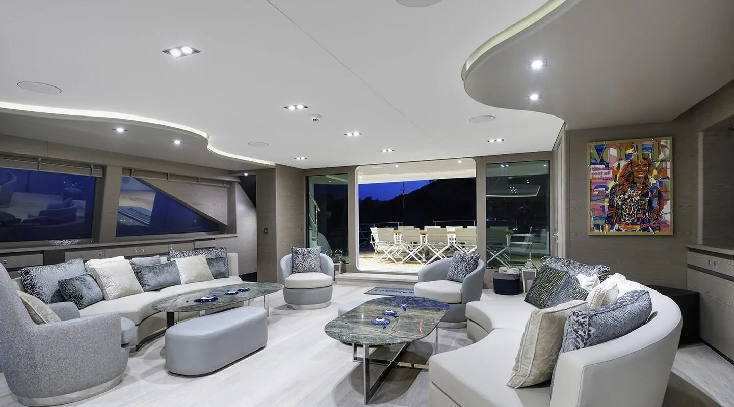 All About U 2 interior salon at night with curved white seating and marble coffee tables