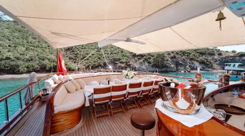 Aft deck of Lycian Queen gulet with wood seating and shaded canopy