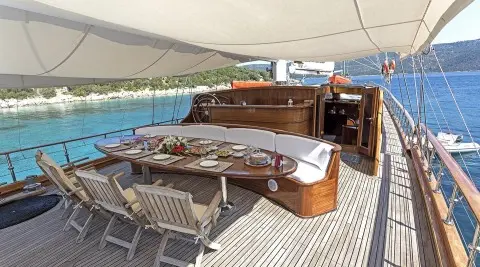 Grace 1 yacht deck with teak finish, shaded dining area and ocean view