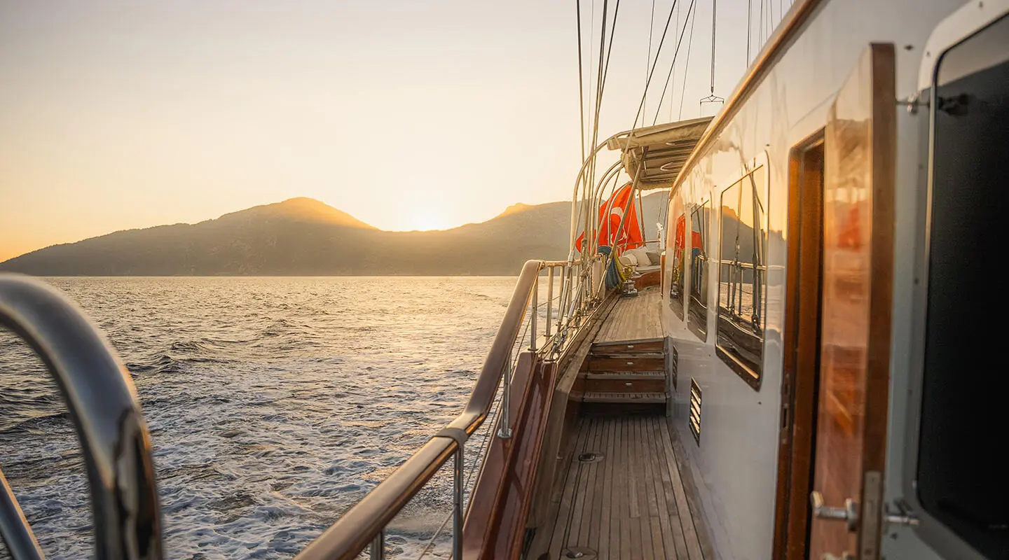 Gulet La Bella Vita side deck with railings, sunset over calm sea