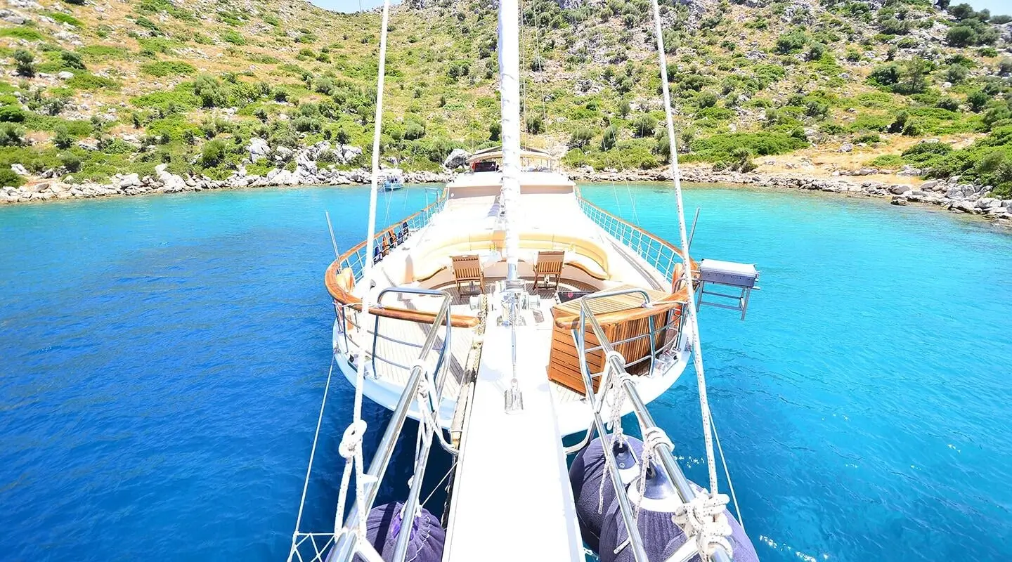 View from front of Prenses Bugce yacht with moored bow, clear blue water