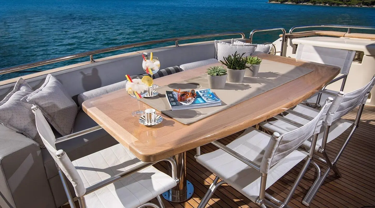 Outdoor dining on Salt yacht deck with table set and ocean view