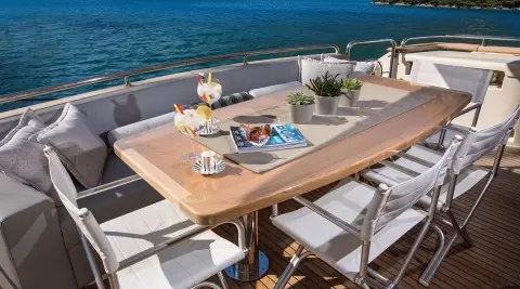Outdoor dining on Salt yacht deck with table set and ocean view