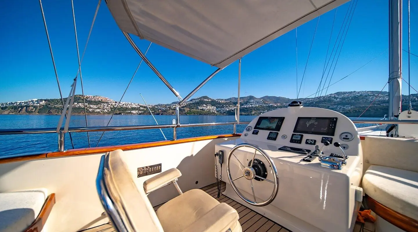Bridge cockpit of Double Eagle luxury yacht at sunset with seats and helm