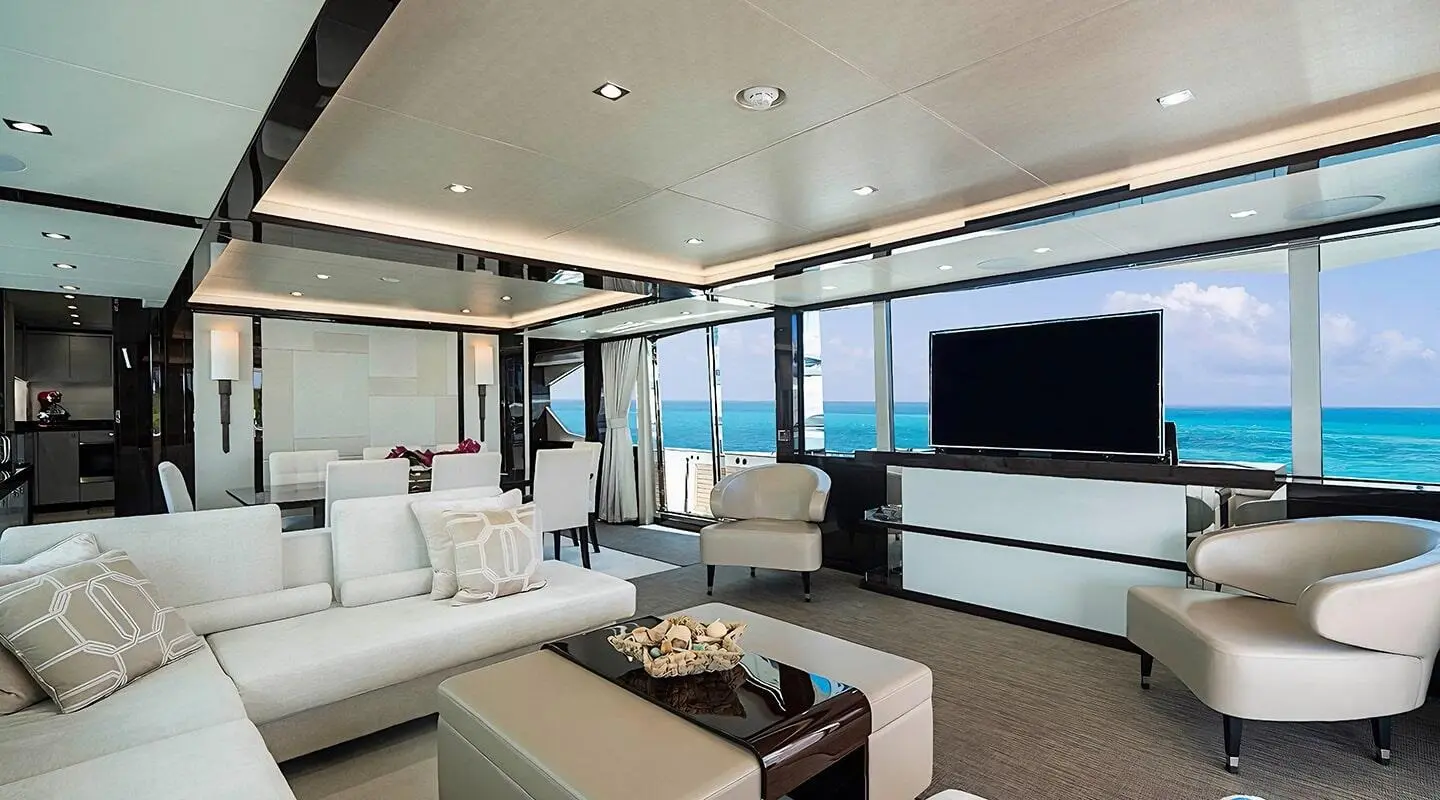 Inside the Quantum yacht saloon with seating, cushions, and large windows