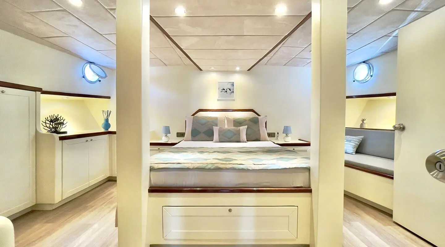 View of Derya Deniz gulet master cabin, with bed and wooden furnishings