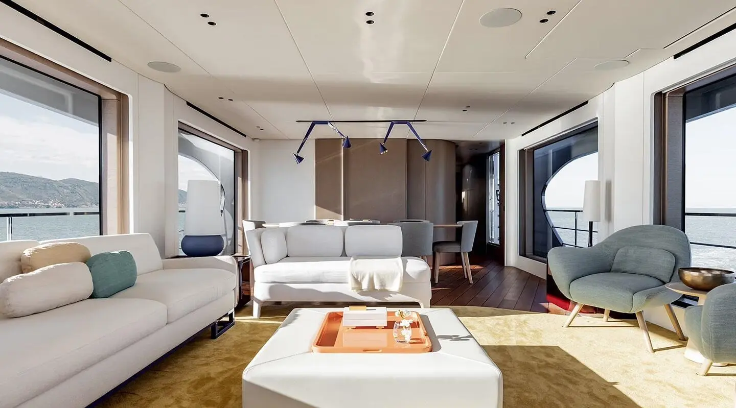 Viva II yacht interior saloon with white sofas and a wooden coffee table