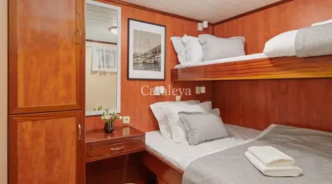 Gulet Cataleya cabin with double bed and bunk bed in warm wooden interior