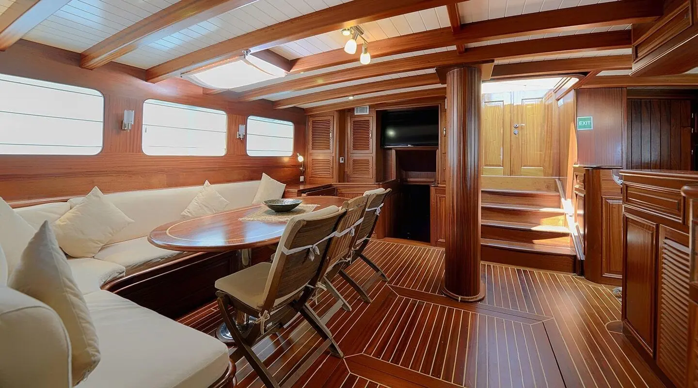 Zephyria II interior yacht deck with seating, wooden floors, and warm lighting