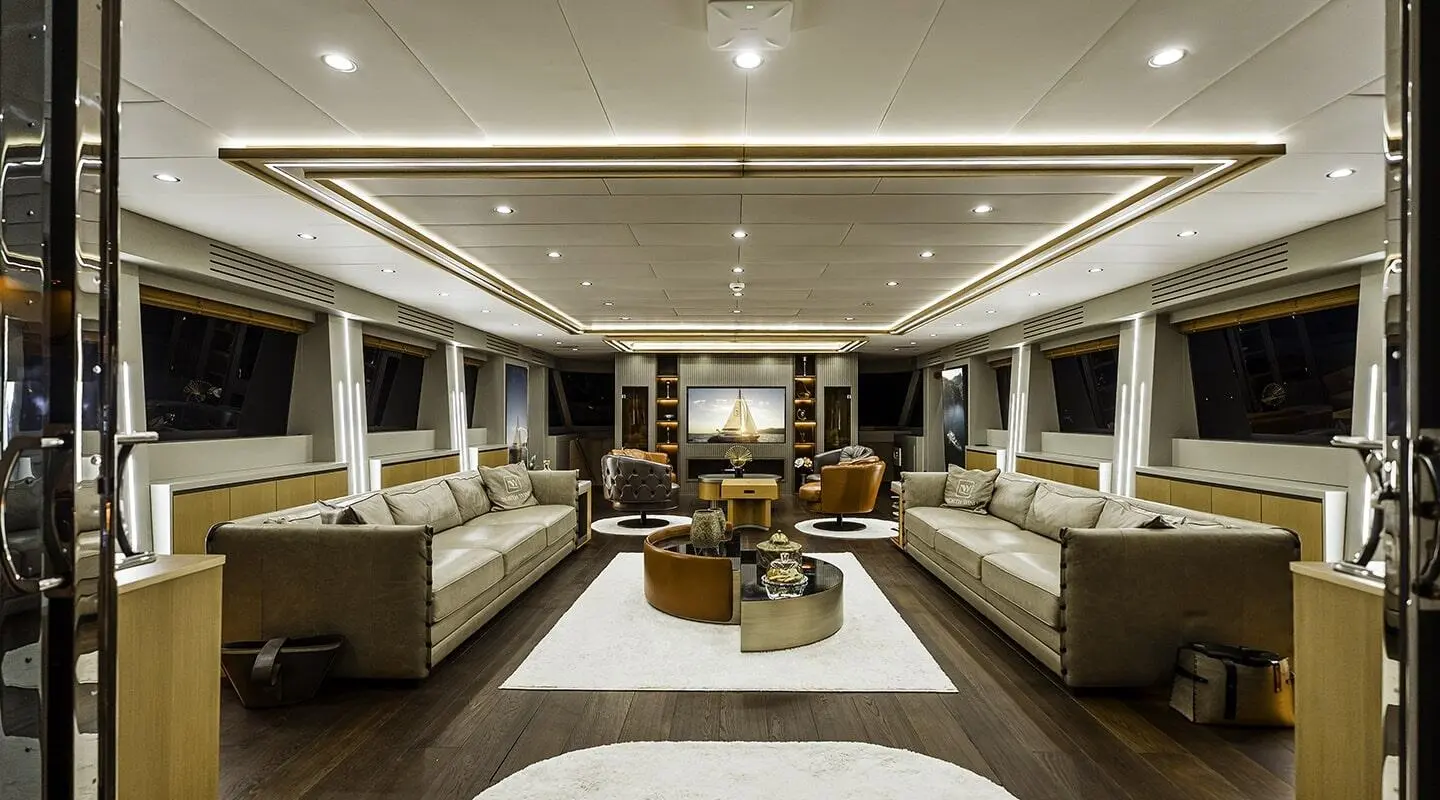 Luxurious yacht interior salon with cream seating and dark wood accents