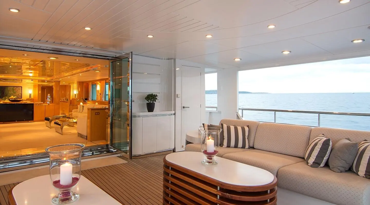 O'Natalina yacht sunset deck scene with seating, table, and windows