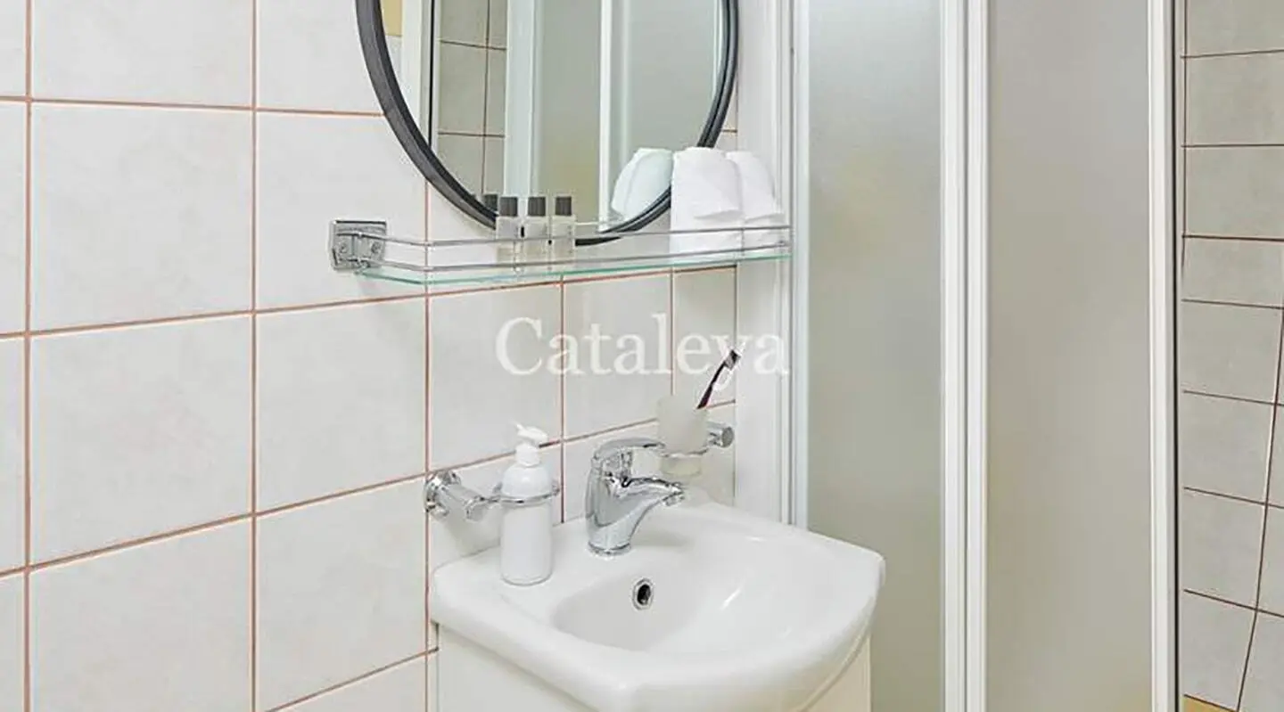 Bathroom aboard Gulet Cataleya with sink, mirror, faucet, and tiled walls