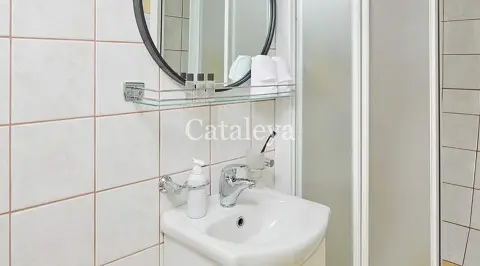 Bathroom aboard Gulet Cataleya with sink, mirror, faucet, and tiled walls
