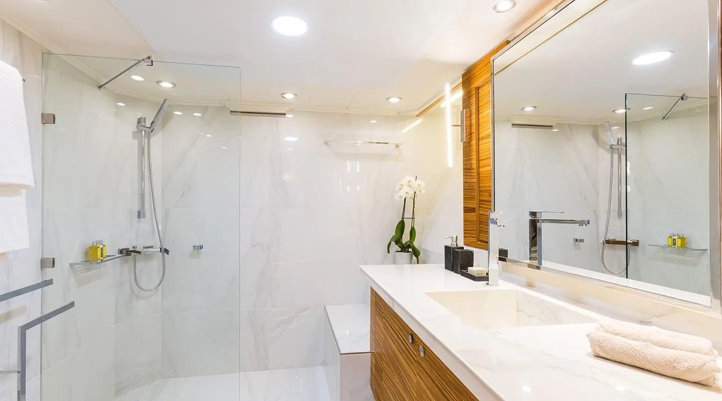 Aquarella yacht interior: glossy marble walls, wooden vanity, and sink area