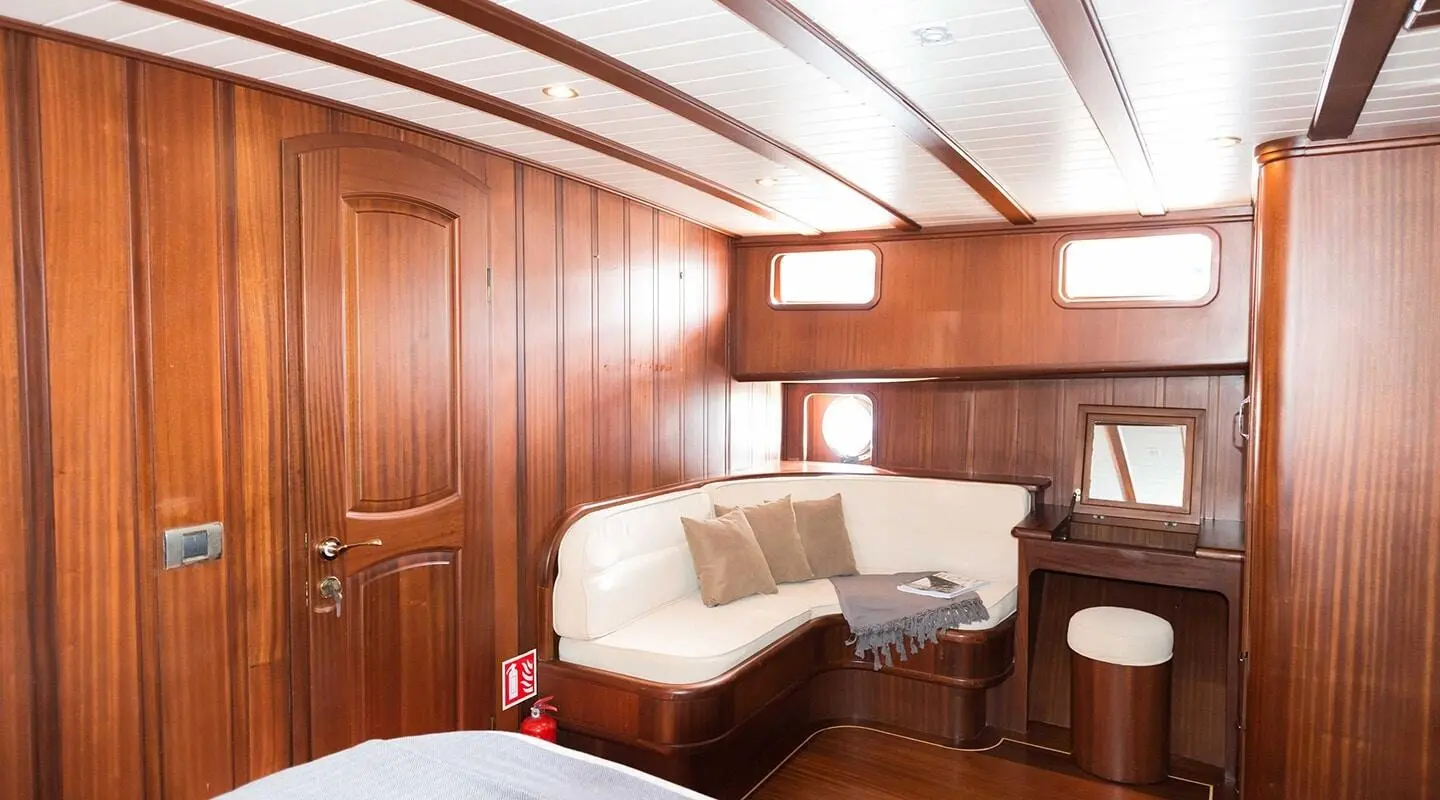 Interior view of Primadonna yacht saloon with wooden panels and seating