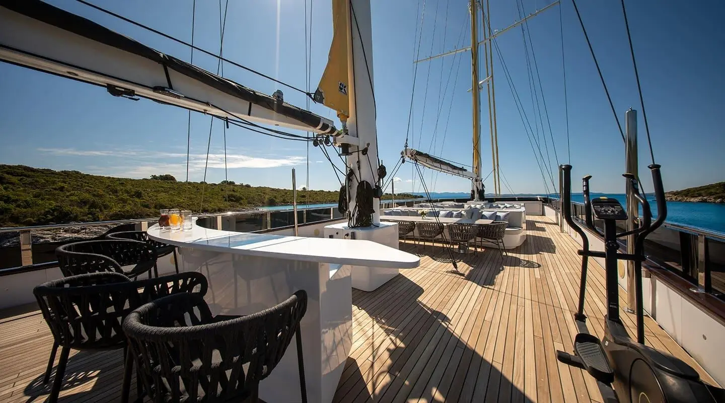 Yacht Anima Maris on sun deck with seating and railing on calm water