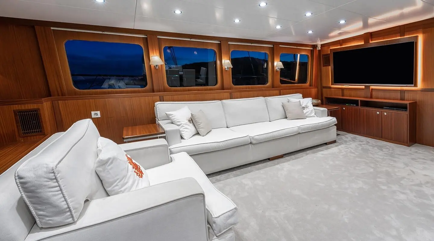 Luxurious yacht Lucky You at sunset with white seating on deck