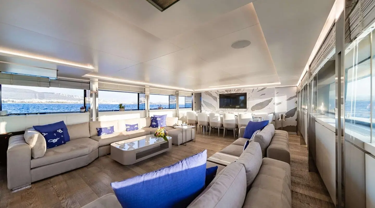 Spacious yacht salon aboard Sea Wolf with blue and gray seating, bright lighting